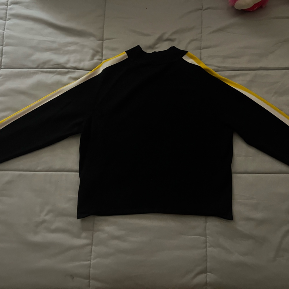 Fitted black shirt with yellow and white lines  turtle neck